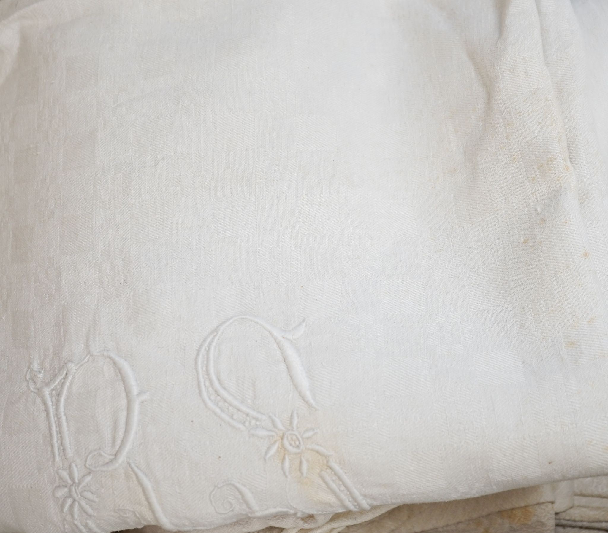 Two French provincial thick linen monogrammed tablecloths and three others.